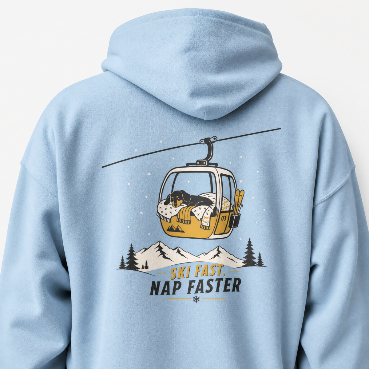 Light blue hoodie with a graphic of a dog in a gondola lift and text 'Ski Fast, Nap Faster' on the back.