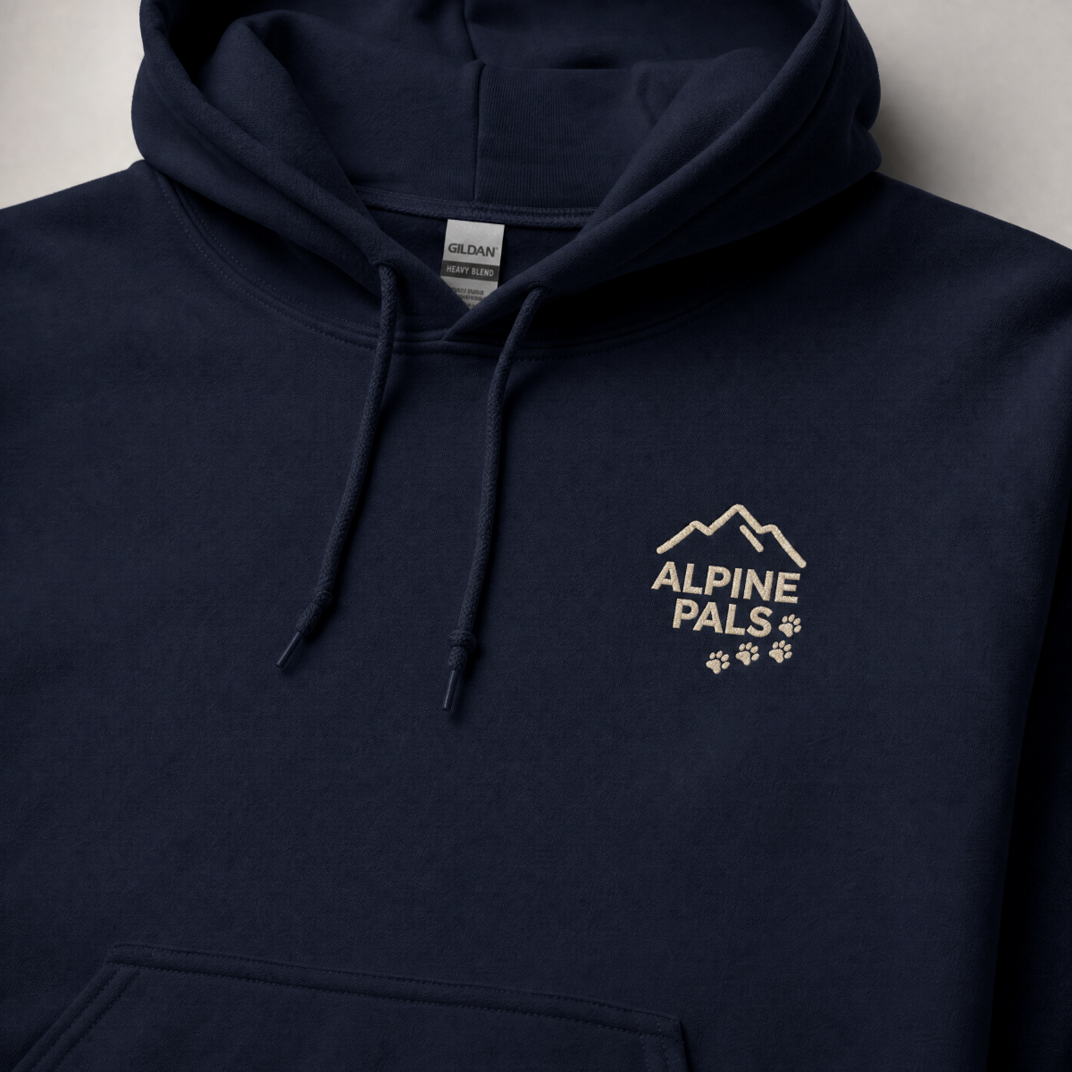 Navy blue hoodie with 'Alpine Pals' logo on a light gray background