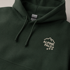 Forest green hoodie with 'Alpine Pals' logo on a neutral background