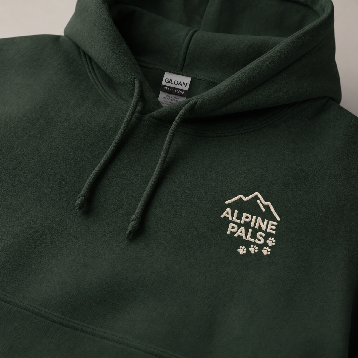 Forest green hoodie with 'Alpine Pals' logo on a neutral background