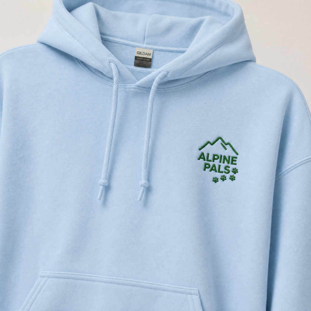 Light blue hoodie with 'Alpine Pals' logo on a beige background