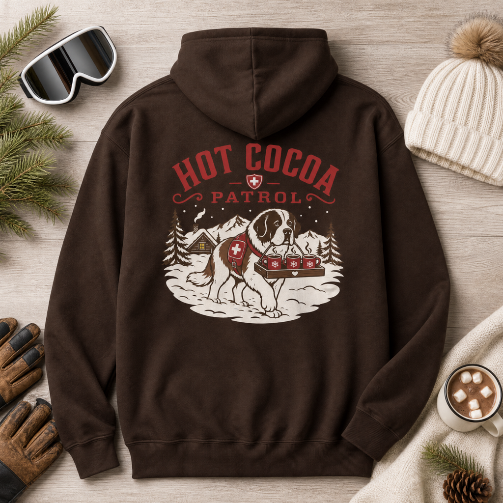 Dark chocolate brown hoodie with 'Hot Cocoa Patrol' graphic on a wooden surface with winter accessories.