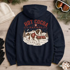 Navy blue hoodie with 'Hot Cocoa Patrol' graphic on a wooden surface with winter accessories.