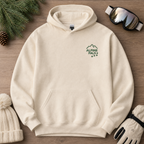 Sand colored hoodie with 'Alpine Pals' logo on a wooden surface with winter accessories.