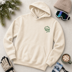Sand colored hoodie with 'Alpine Pals' logo on a light surface with winter accessories.