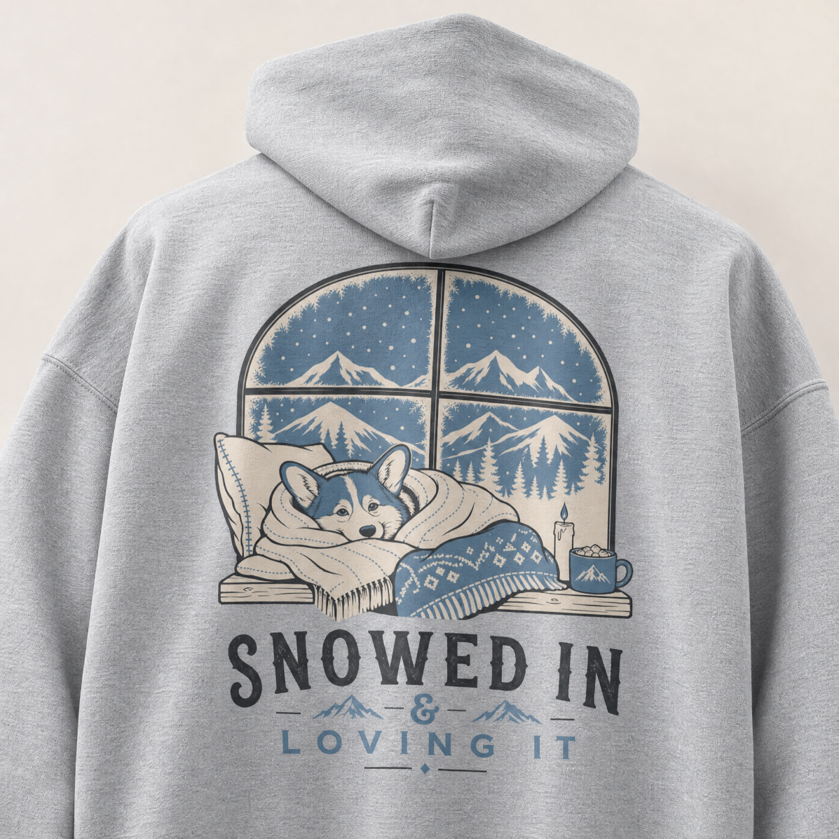 Sport grey hoodie with a graphic of a dog in bed and 'Snowed In & Loving It' text on the back.
