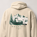 Sand colored hoodie with a graphic of a dog in a hot tub surrounded by mountains and trees on the back.