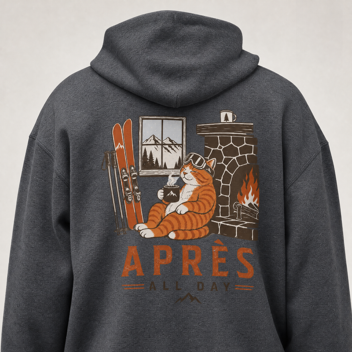 Dark heather gray hoodie with a cat-themed graphic on the back, featuring skis, a fireplace, and the text 'APRèS ALL DAY'.