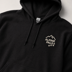 Black hoodie with 'Alpine Pals' logo on a light gray background