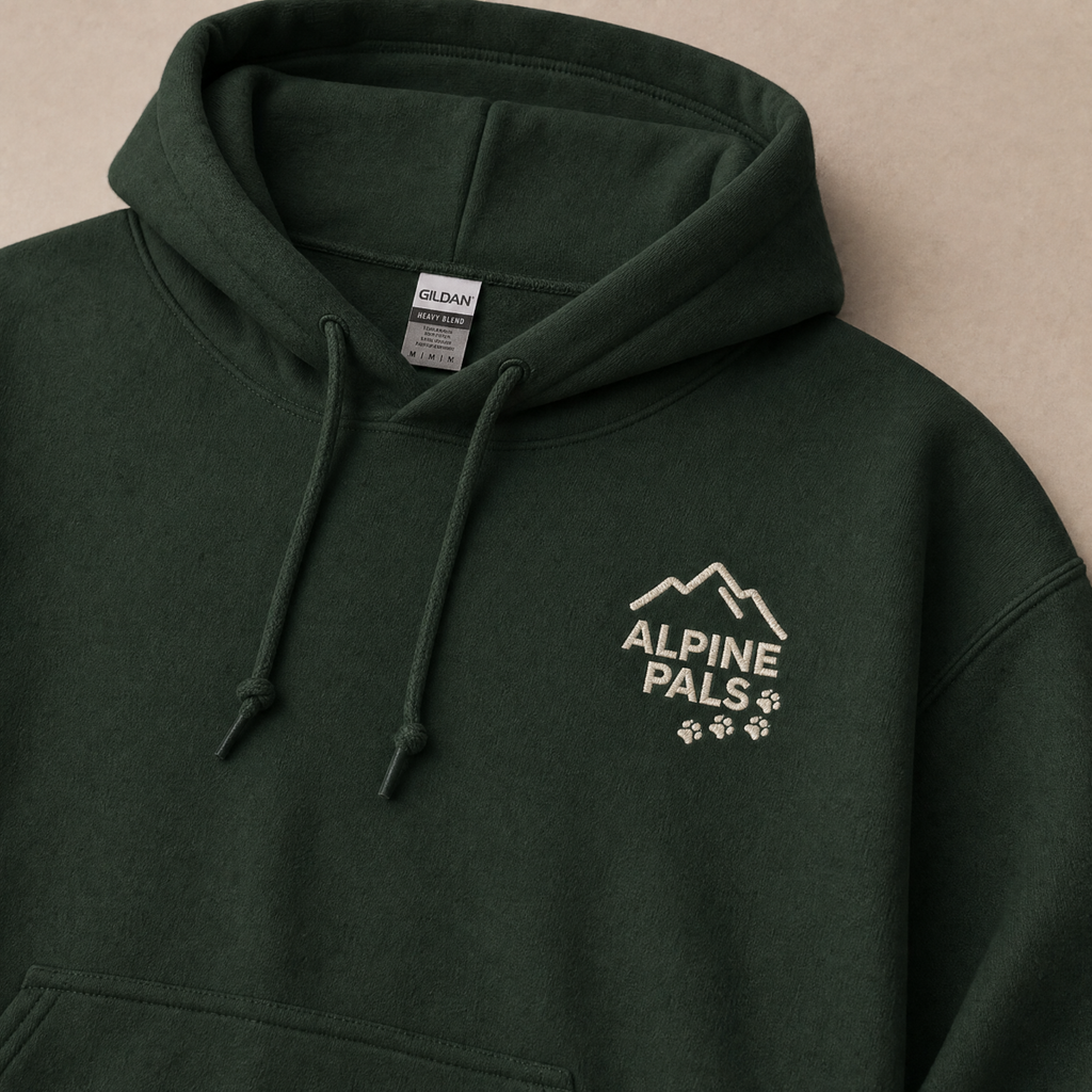 Forest green hoodie with 'Alpine Pals' logo on a beige background