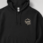 Black hoodie with 'Alpine Pals' logo on a light gray background