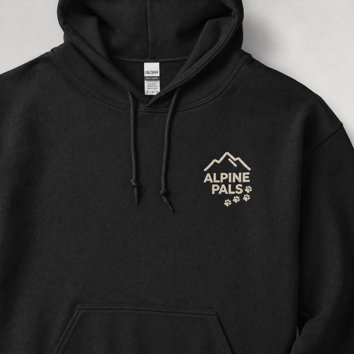Black hoodie with 'Alpine Pals' logo on a light gray background