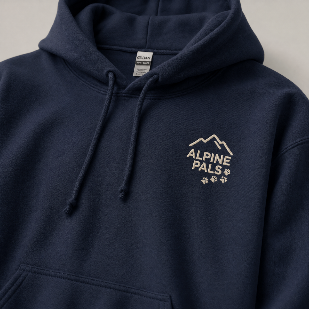 Navy blue hoodie with 'Alpine Pals' logo on a light gray background
