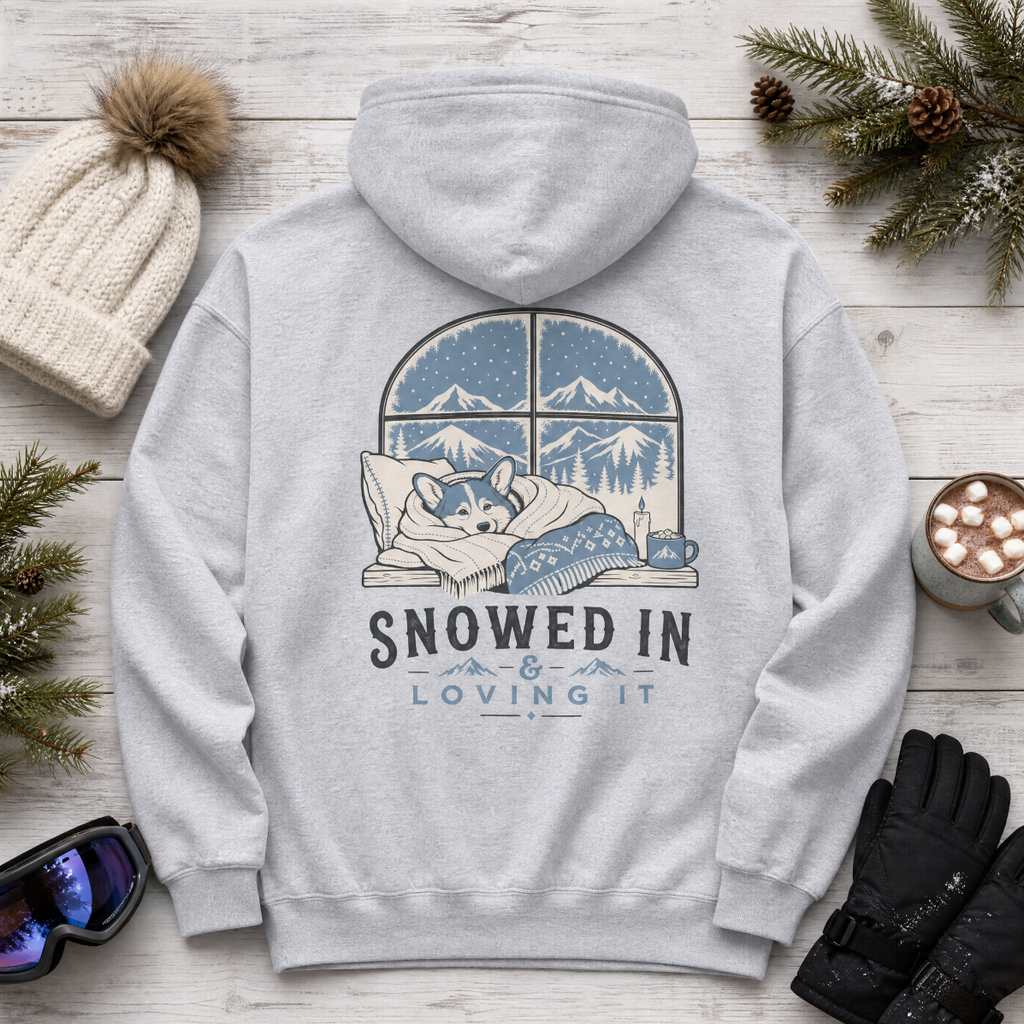 Sport grey hoodie with a winter-themed design on a wooden surface with winter accessories.