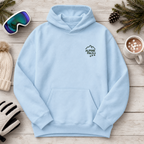 Light blue hoodie with 'Alpine Pals' logo on a wooden surface with winter accessories.