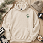 Sand colored hoodie with 'Alpine Pals' logo on a wooden surface with winter accessories.