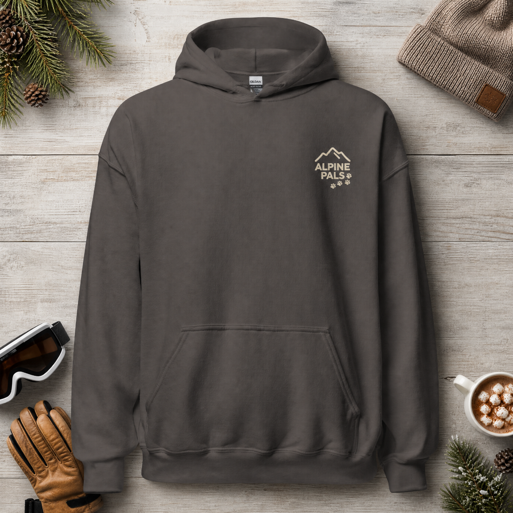 Charcoal gray hoodie with 'Alpine Pals' logo on a wooden surface with winter accessories.