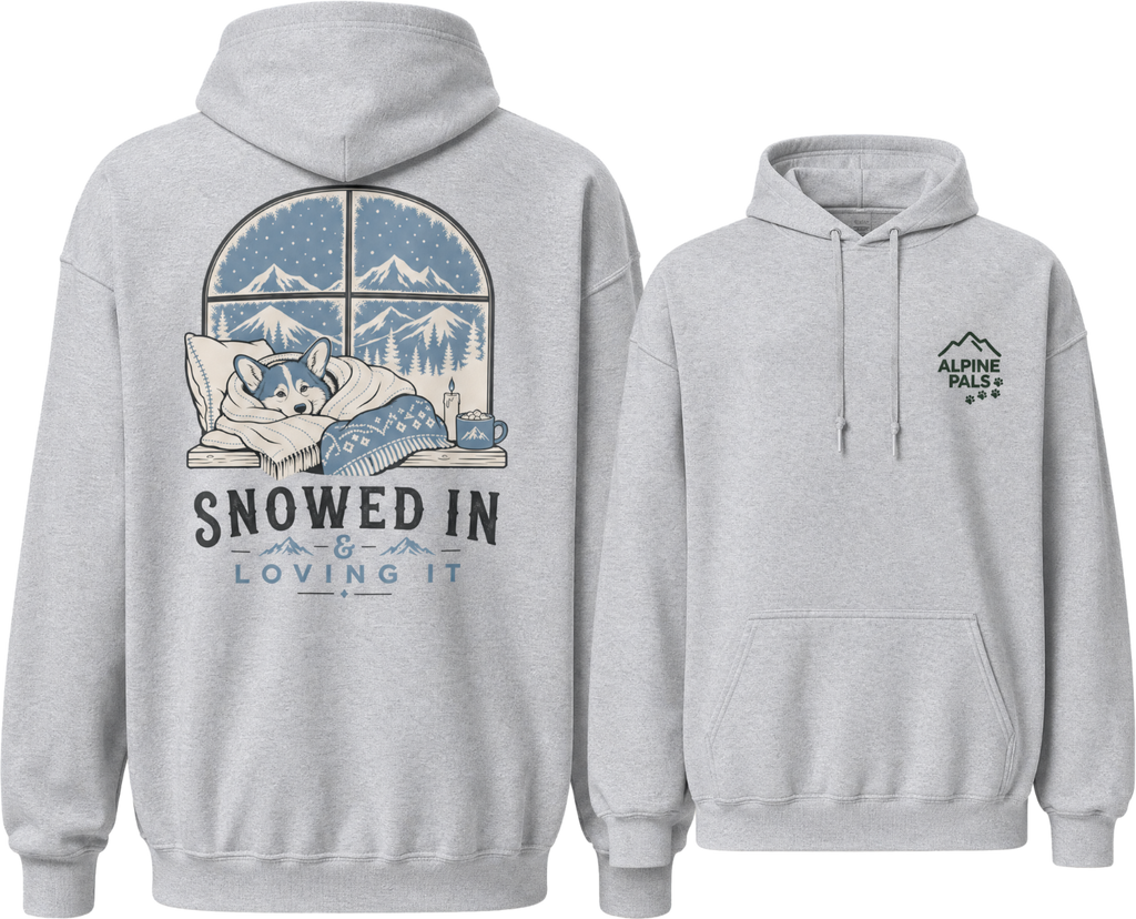 Sport grey hoodie with a graphic of a dog in a window and 'Snowed In & Loving It' text on the front, and a logo on the back.