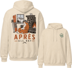 Sand colored hoodie with a graphic of a cat by a fireplace and skis, with 'Apres All Day' text on the front, and a logo on the sleeve.