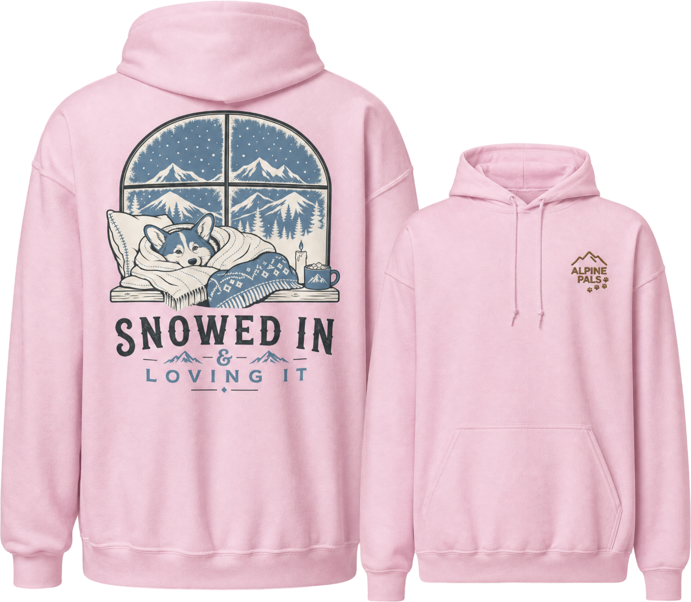 Pink hoodie with a graphic of a dog sleeping under a blanket and mountains, with text 'Snowed In & Loving It' on the front.