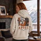 Person wearing a hoodie with a graphic design and text in a cozy room with a view of mountains.