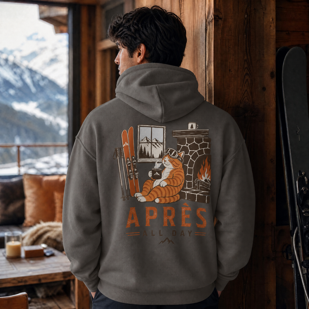 Person wearing a hoodie with a 'Apres Ski All Day' design in a mountain lodge setting