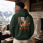 Person wearing a forest green hoodie with a graphic design in a cozy cabin setting