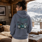 Person wearing a Heather sport dark navy hoodie with a graphic design, standing in a cozy room with a snowy mountain view.