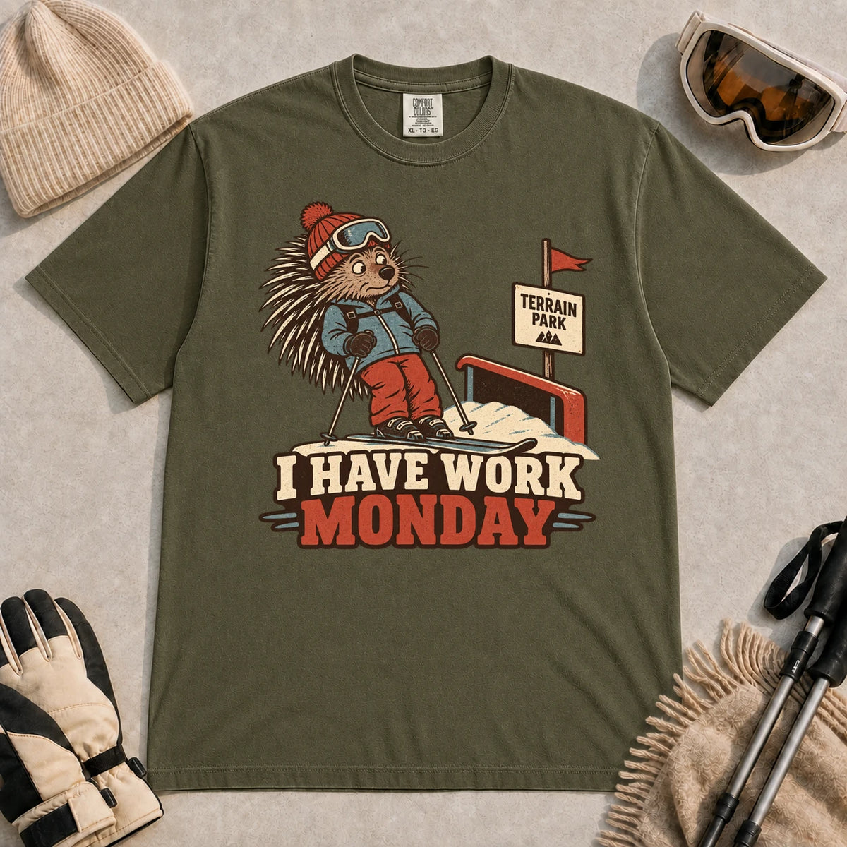 Hemp tee featuring a cautious porcupine skier beside a terrain park rail and sign above the phrase “I Have Work Monday.”