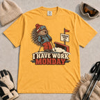 Mustard tee featuring a cautious porcupine skier beside a terrain park rail and sign above the phrase “I Have Work Monday.”