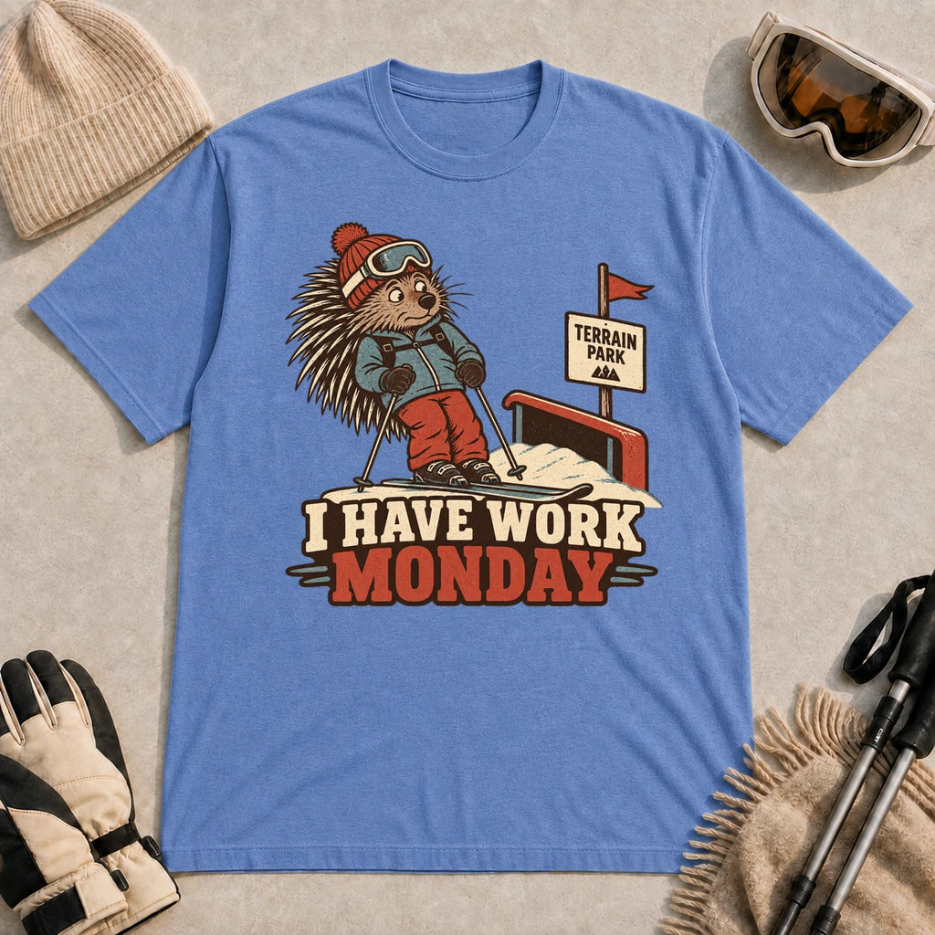 Heather Royal tee featuring a cautious porcupine skier beside a terrain park rail and sign above the phrase “I Have Work Monday.”