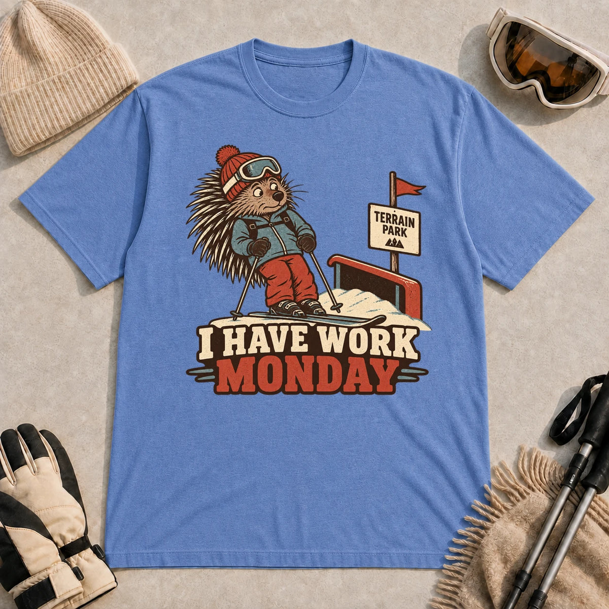 Heather Royal tee featuring a cautious porcupine skier beside a terrain park rail and sign above the phrase “I Have Work Monday.”