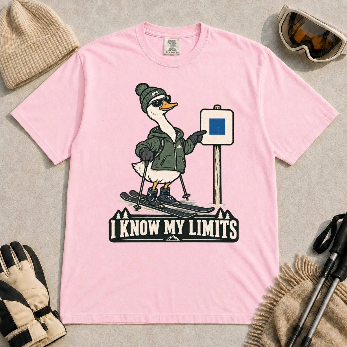 Blossom tee featuring a cool duck skier pointing to a blue-square trail sign above the phrase “I Know My Limits.”
