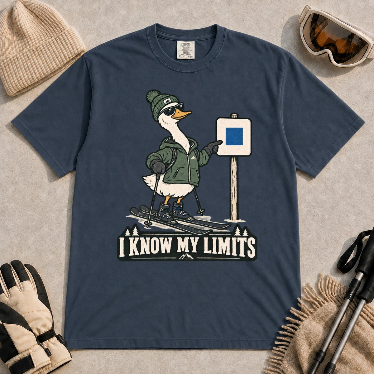 Midnight tee featuring a cool duck skier pointing to a blue-square trail sign above the phrase “I Know My Limits.”