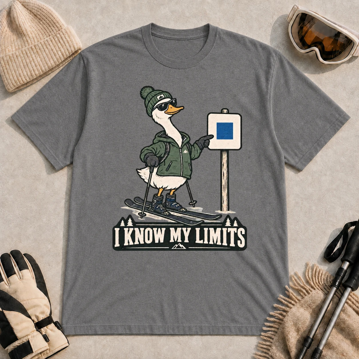 Graphite Heather tee featuring a cool duck skier pointing to a blue-square trail sign above the phrase “I Know My Limits.”