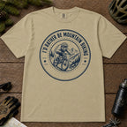 Khaki tee featuring a helmeted bear mountain biking inside a circular mountain badge with the phrase “I’d Rather Be Mountain Biking.”