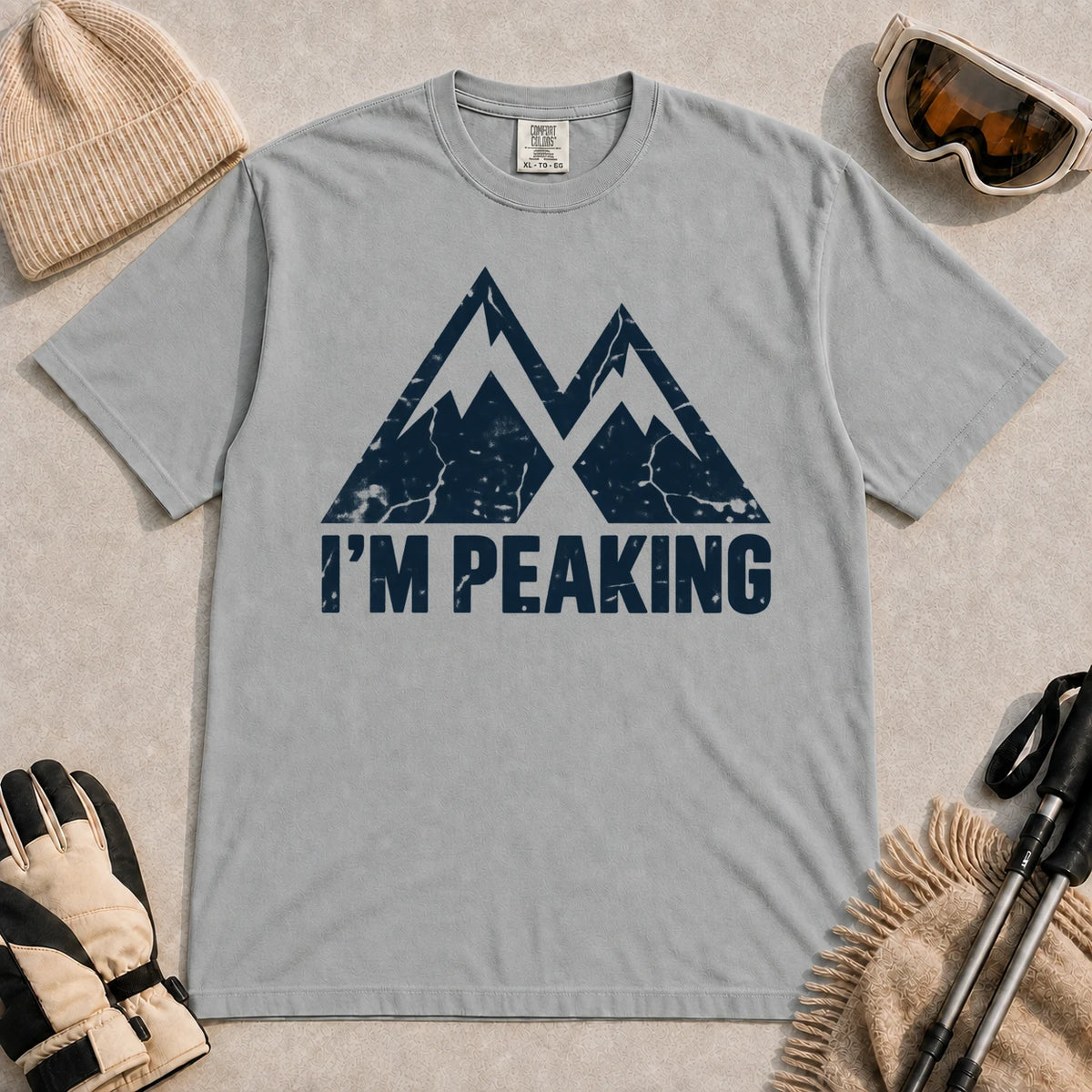 Granite tee featuring a distressed navy double-mountain graphic above the phrase “I’m Peaking.”