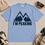 Washed Denim tee featuring a distressed navy double-mountain graphic above the phrase “I’m Peaking.”