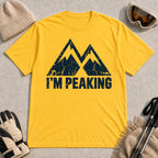 Daisy tee featuring a distressed navy double-mountain graphic above the phrase “I’m Peaking.”