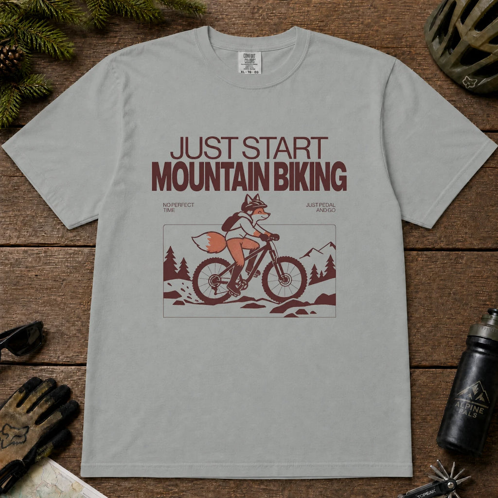 Granite tee featuring a fox mountain biking through a minimalist trail scene with the phrases “Just Start Mountain Biking,” “No Perfect Time,” and “Just Pedal and Go.”