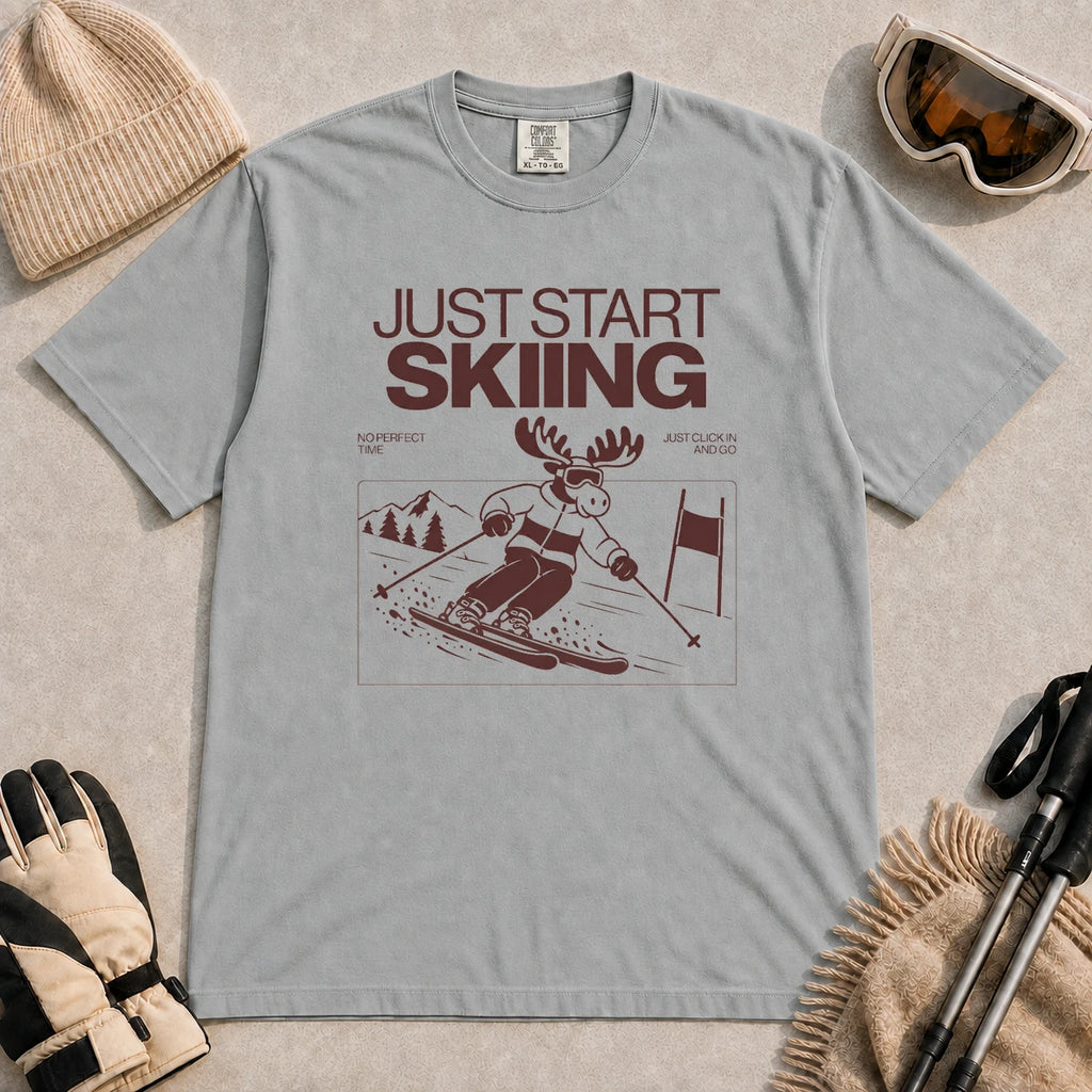 Granite tee featuring a moose skiing through a minimalist mountain scene with the phrases “Just Start Skiing,” “No Perfect Time,” and “Just Click In and Go.”