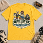 Daisy tee featuring a bear, bunny, and raccoon in ski gear above a retro “Mediocre Ski Club” badge with the phrases “Proudly Intermediate” and “Blues, Brews, and Back by 4.”