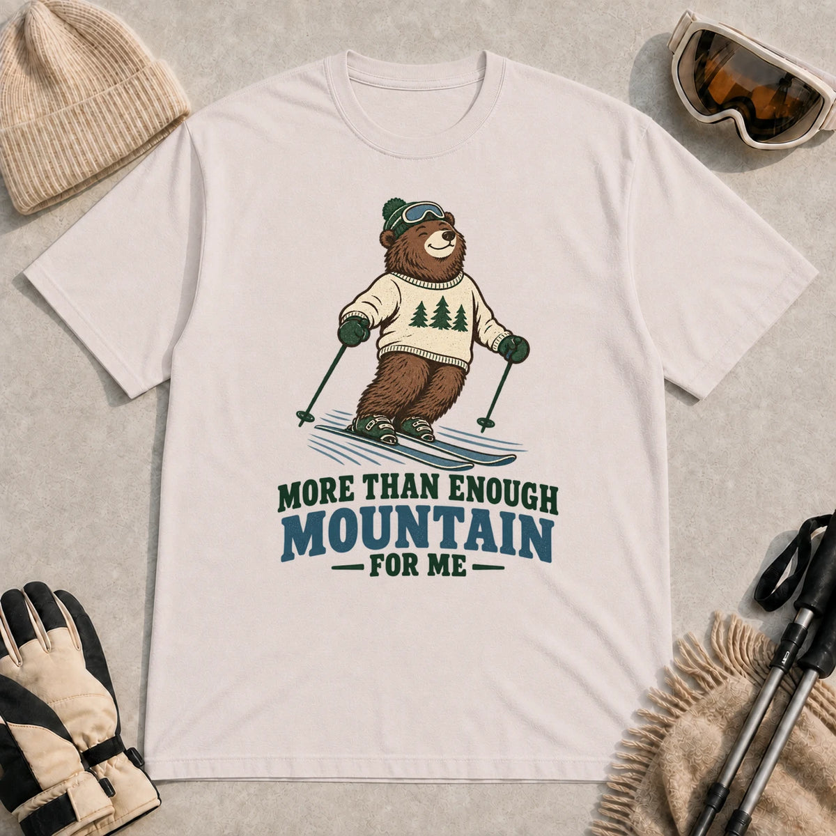 Ice Grey tee featuring a smiling bear skiing in retro mountain gear above the phrase “More Than Enough Mountain for Me.”