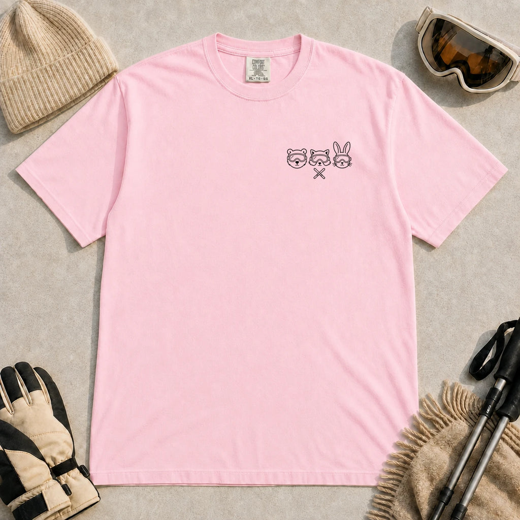 Blossom tee featuring minimalist black line art of a bear, raccoon, and bunny wearing ski goggles above a small pair of crossed skis.