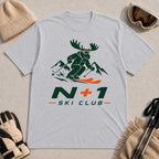 Sport Grey tee featuring a moose skiing through the mountains in a bold green and orange graphic, with the phrase “N+1 Ski Club.”
