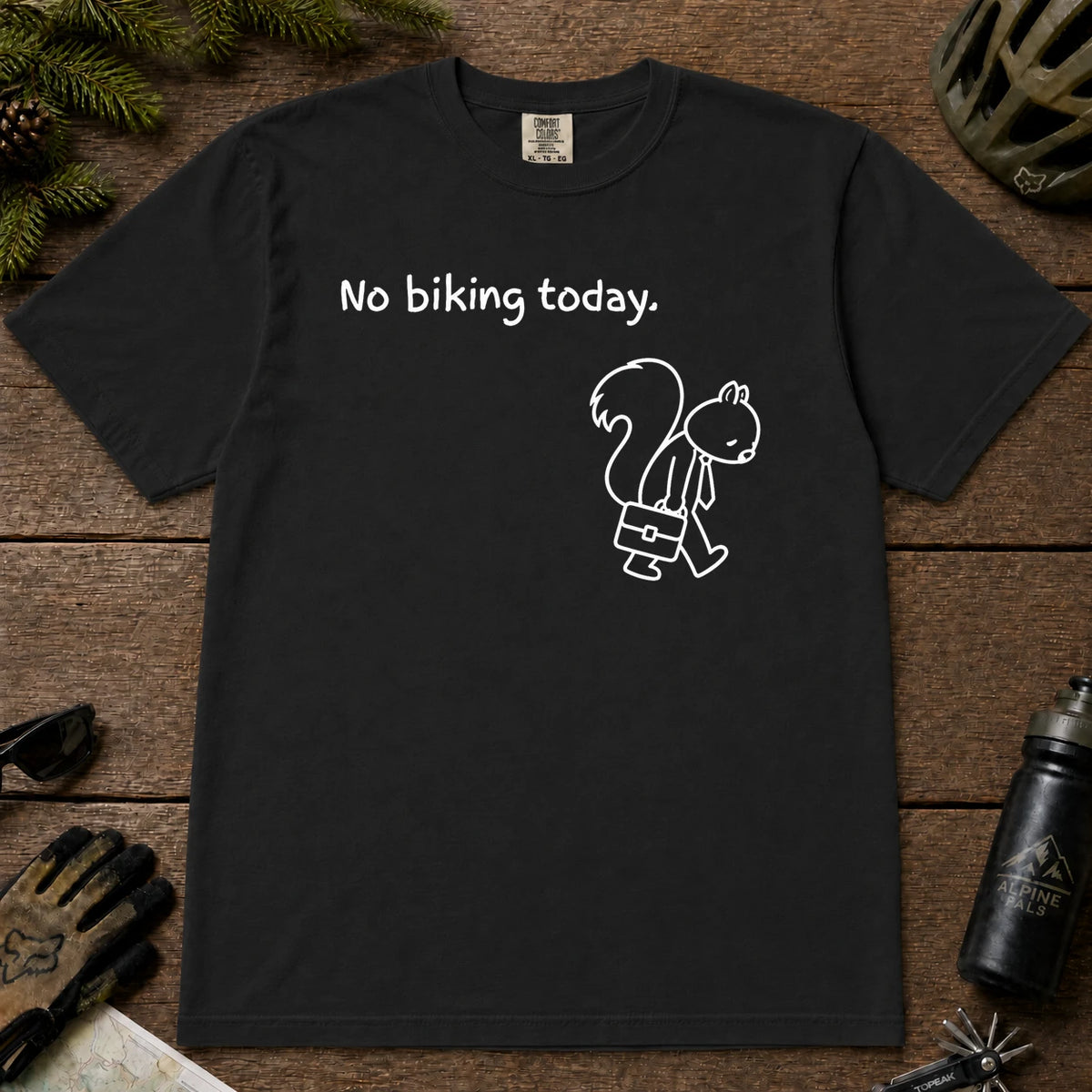 Black tee featuring a sad squirrel dressed for work and carrying a briefcase beneath the phrase “No biking today.”