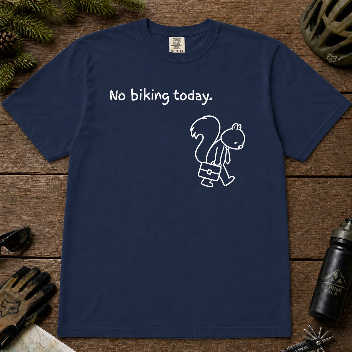 True Navy tee featuring a sad squirrel dressed for work and carrying a briefcase beneath the phrase “No biking today.”