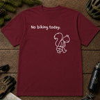 Maroon tee featuring a sad squirrel dressed for work and carrying a briefcase beneath the phrase “No biking today.”