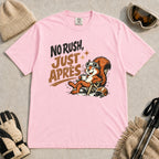 Blossom tee featuring a cheerful squirrel in ski goggles relaxing in a chair with a hot drink and helmet, with the phrase “No Rush, Just Après.”
