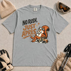 Granite tee featuring a cheerful squirrel in ski goggles relaxing in a chair with a hot drink and helmet, with the phrase “No Rush, Just Après.”